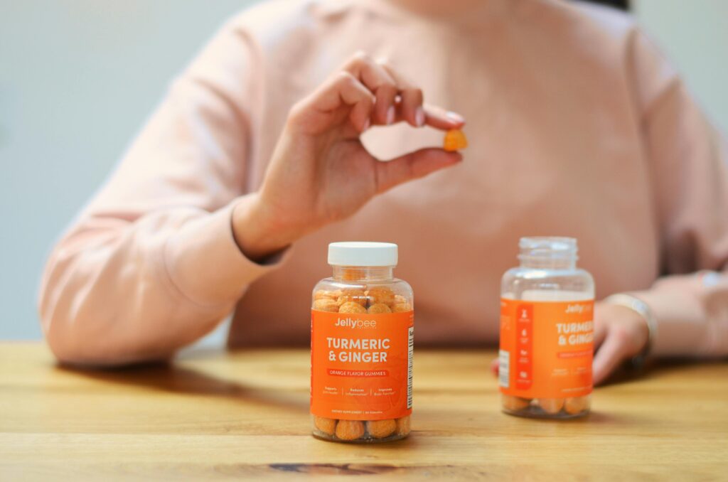 Close-up of turmeric and ginger gummies being held. Perfect for health and wellness content.