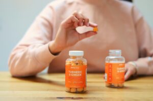 Close-up of turmeric and ginger gummies being held. Perfect for health and wellness content.
